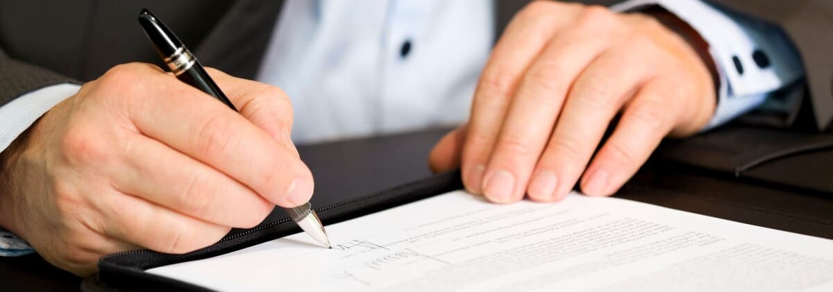 Man signs a document